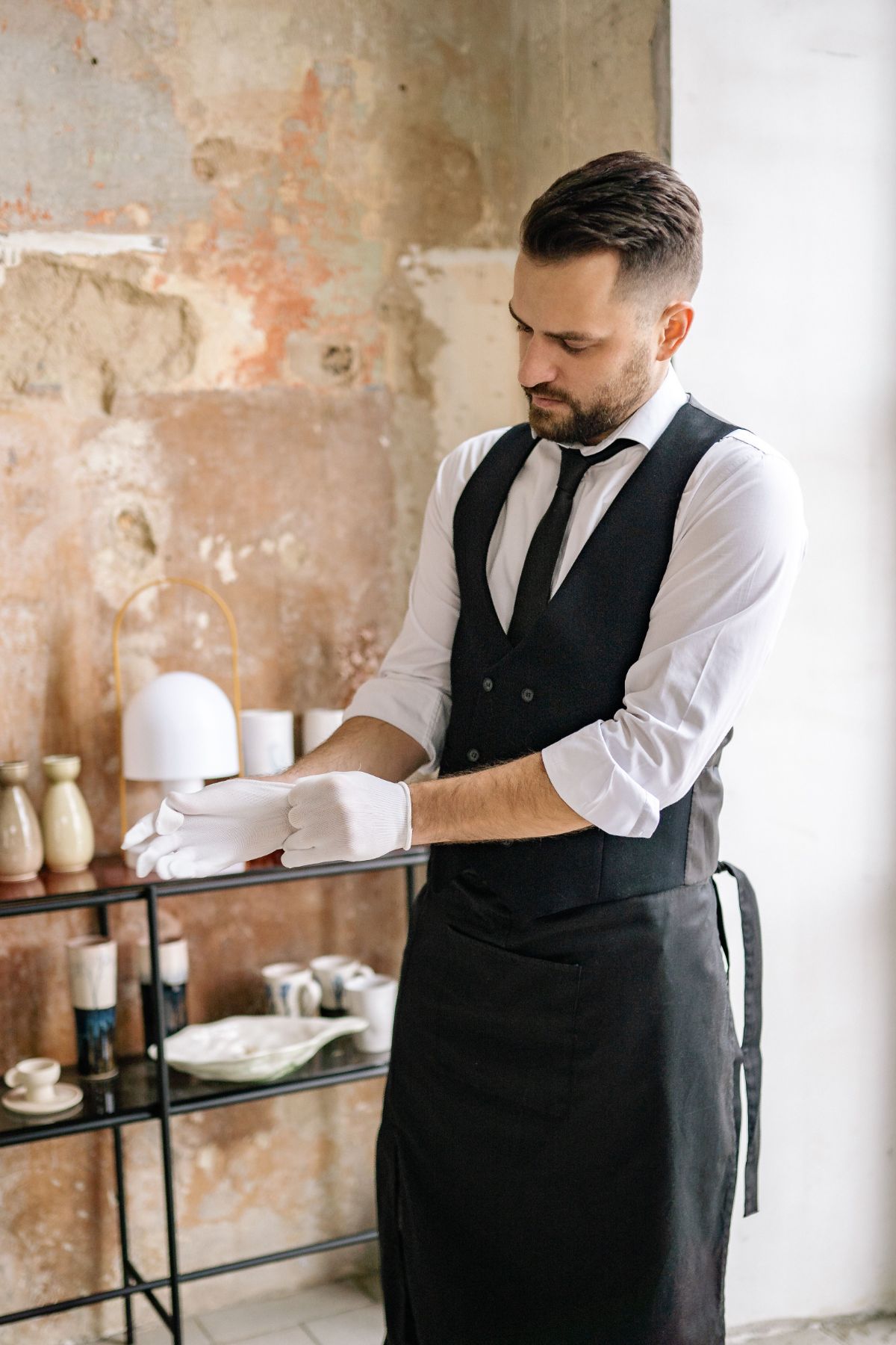 A hotel butler adjusting his glove