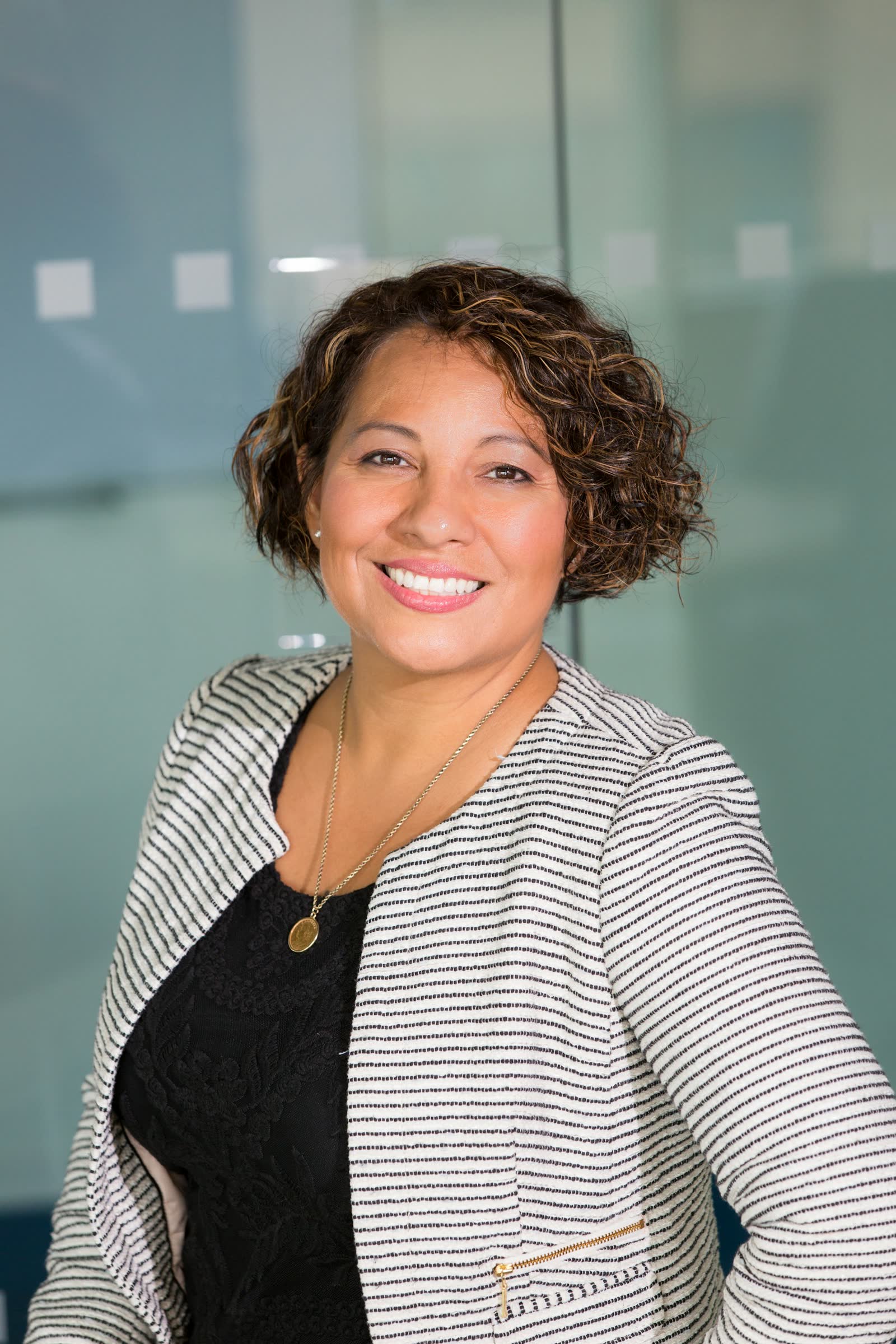 A hotel team member smiling at the front desk
